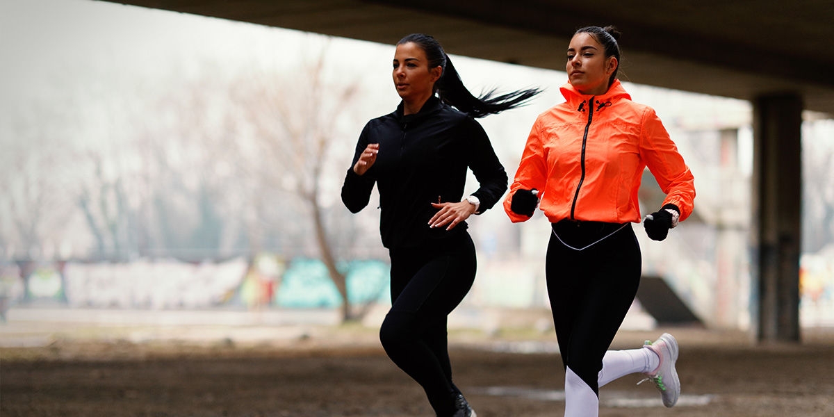 Two women running side by side.