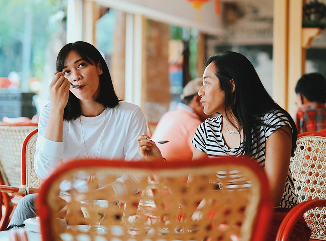 Photo of two women eating in a cafe