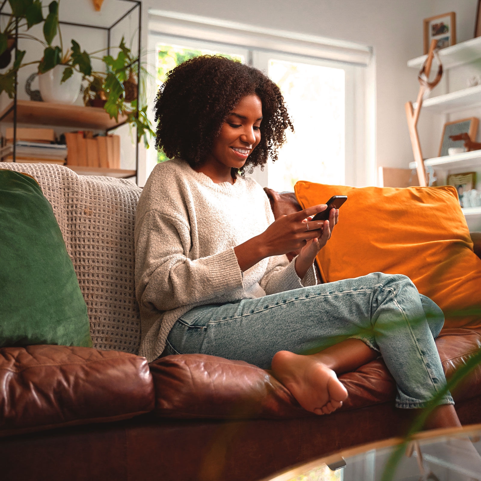 woman sitting phone smiling