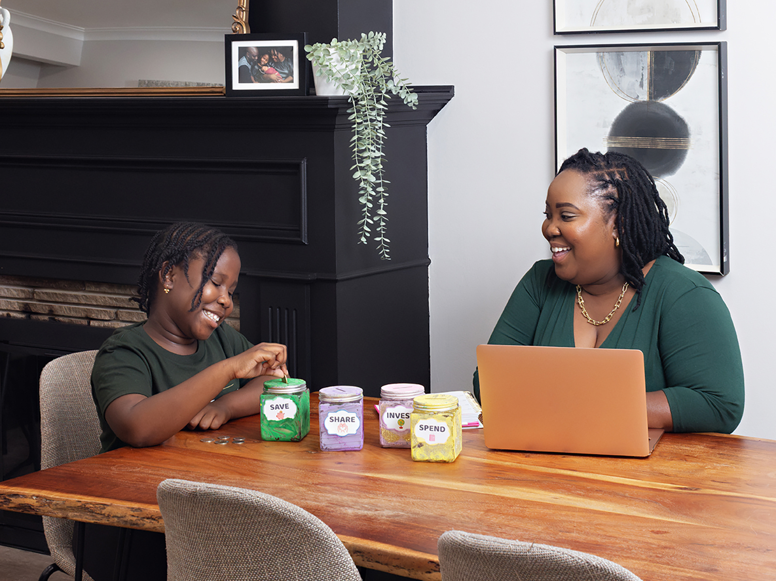 Leah Carr at home with her daughter Mia, demonstrating their "four jar" budgeting system. Photo by Jessica Blaine Smith.