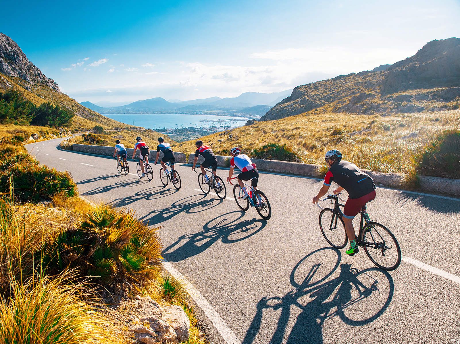 Photo of a group of six cyclists racing down a mountain road.